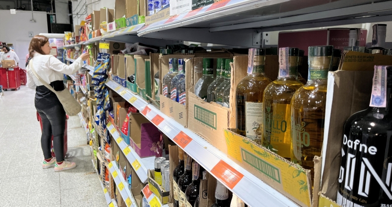 Aguardientes de distintas regiones comparten estantería en un supermercado, una escena impensable durante años. H.E.