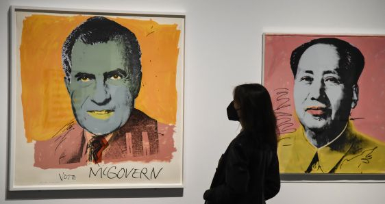 Una visitante de la exposición 'El sueño americano', ante las obras 'Vote McGovern' y 'Mao', de Andy Warhol. FUNDACIÓN "LA CAIXA"