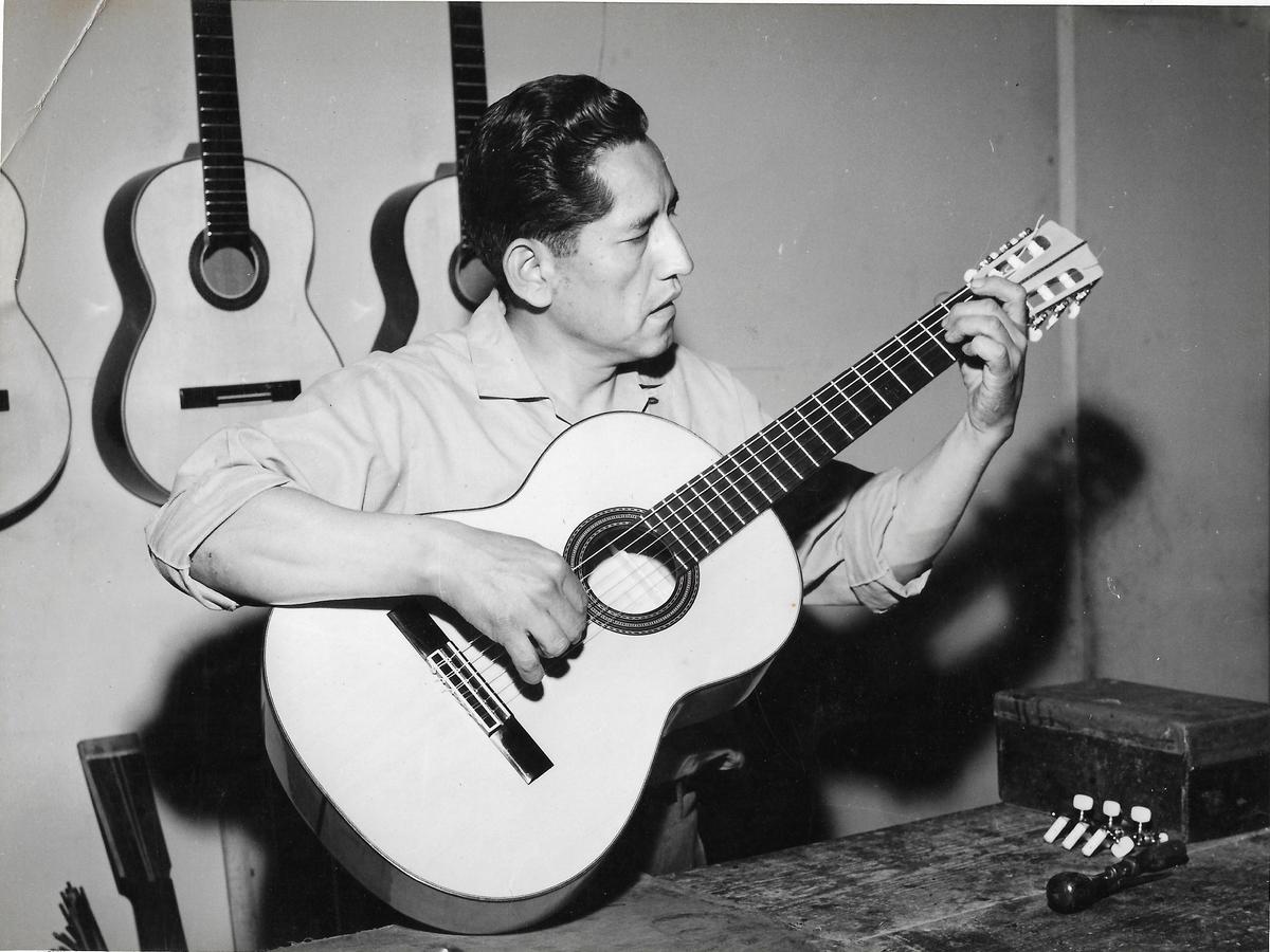 El maestro Abraham Falcón afina una de sus guitarras, en la década de los sesenta. ARCHIVO FAMILIAR